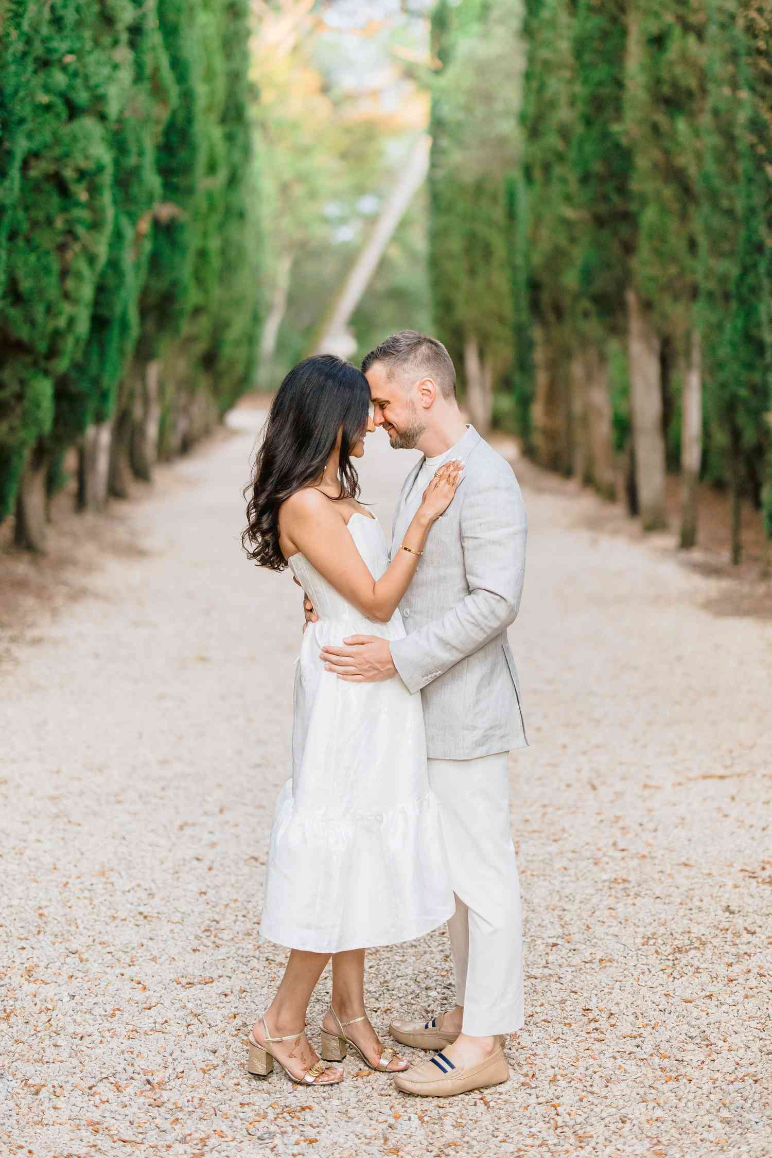 bride and groom hugging facing each other