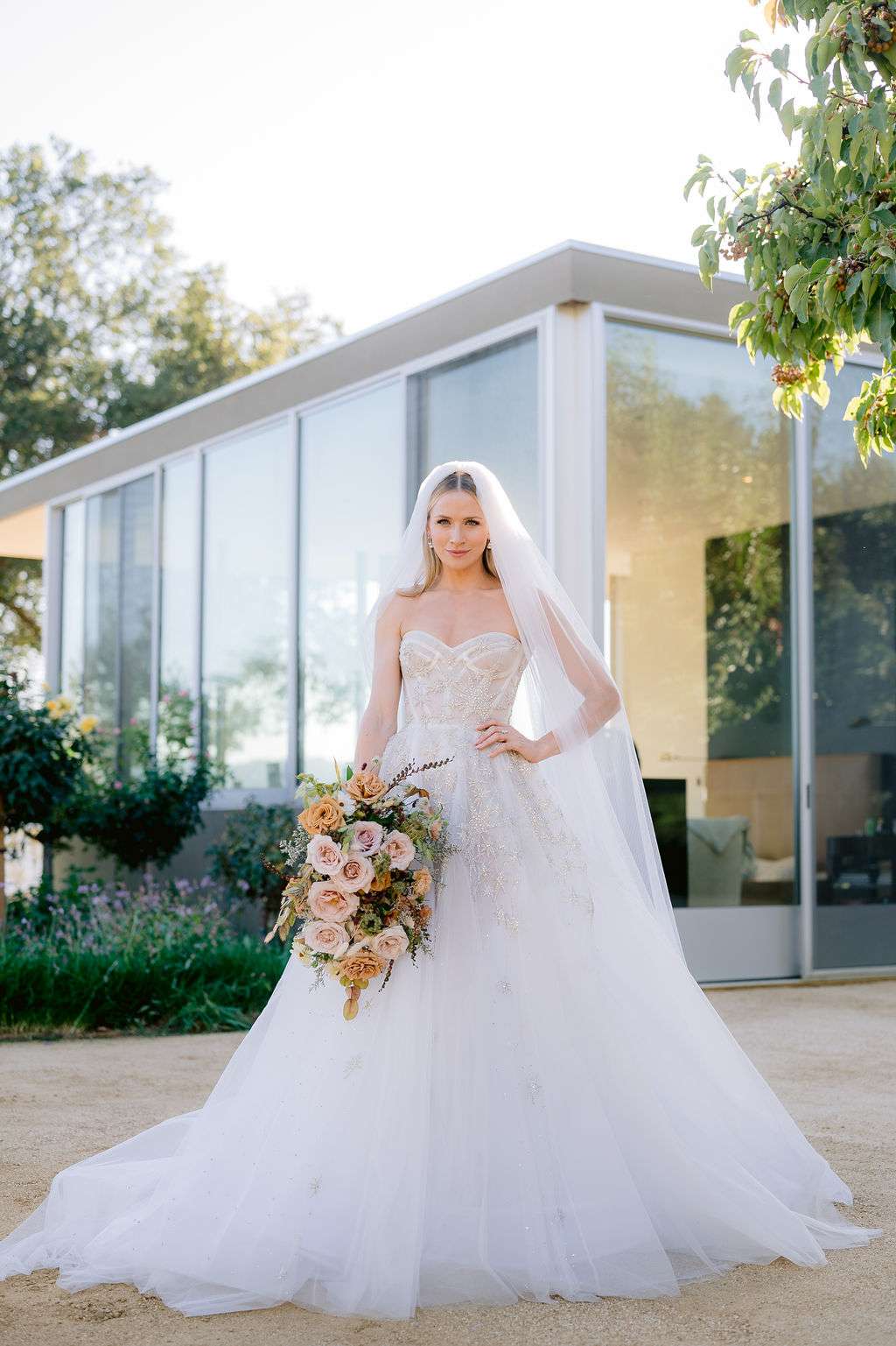 A bride wearing a strapless ball gown with star embellishments and a tulle skirt