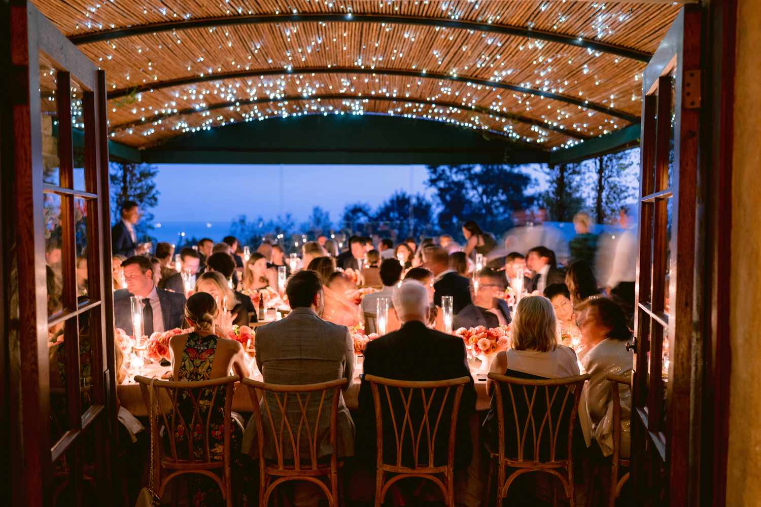 motion blur nighttime image of guests at the dining table chatting