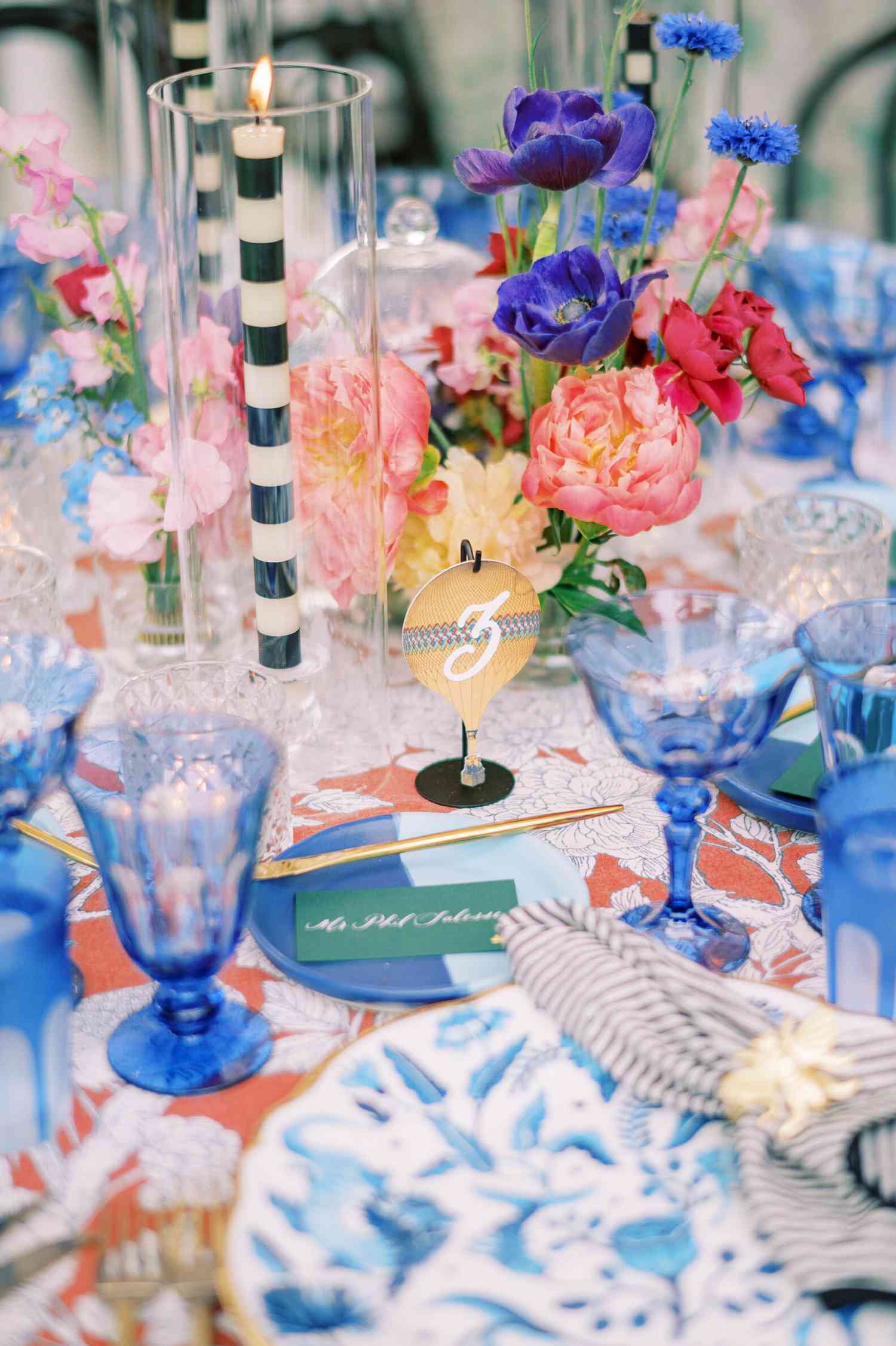 Bright Wedding Reception Tables With Centerpieces of Pink Peonies, Blue Tulips, Pink Sweet Pea, and More