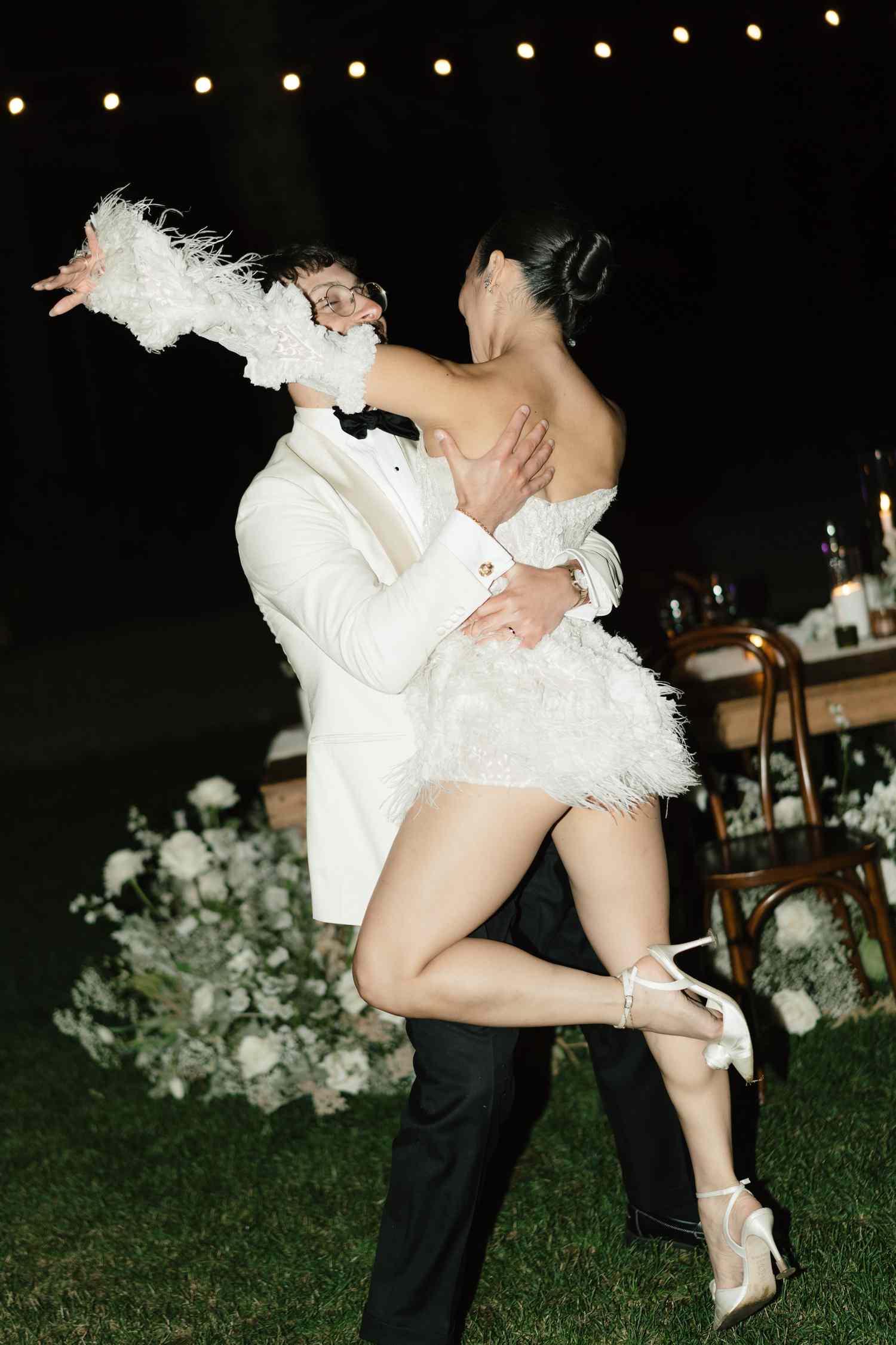 Koko lwasaki in White Mini Wedding Dress With Detached Sleeves and Kiki Nyemchek in White Tuxedo Dancing During Wedding Reception
