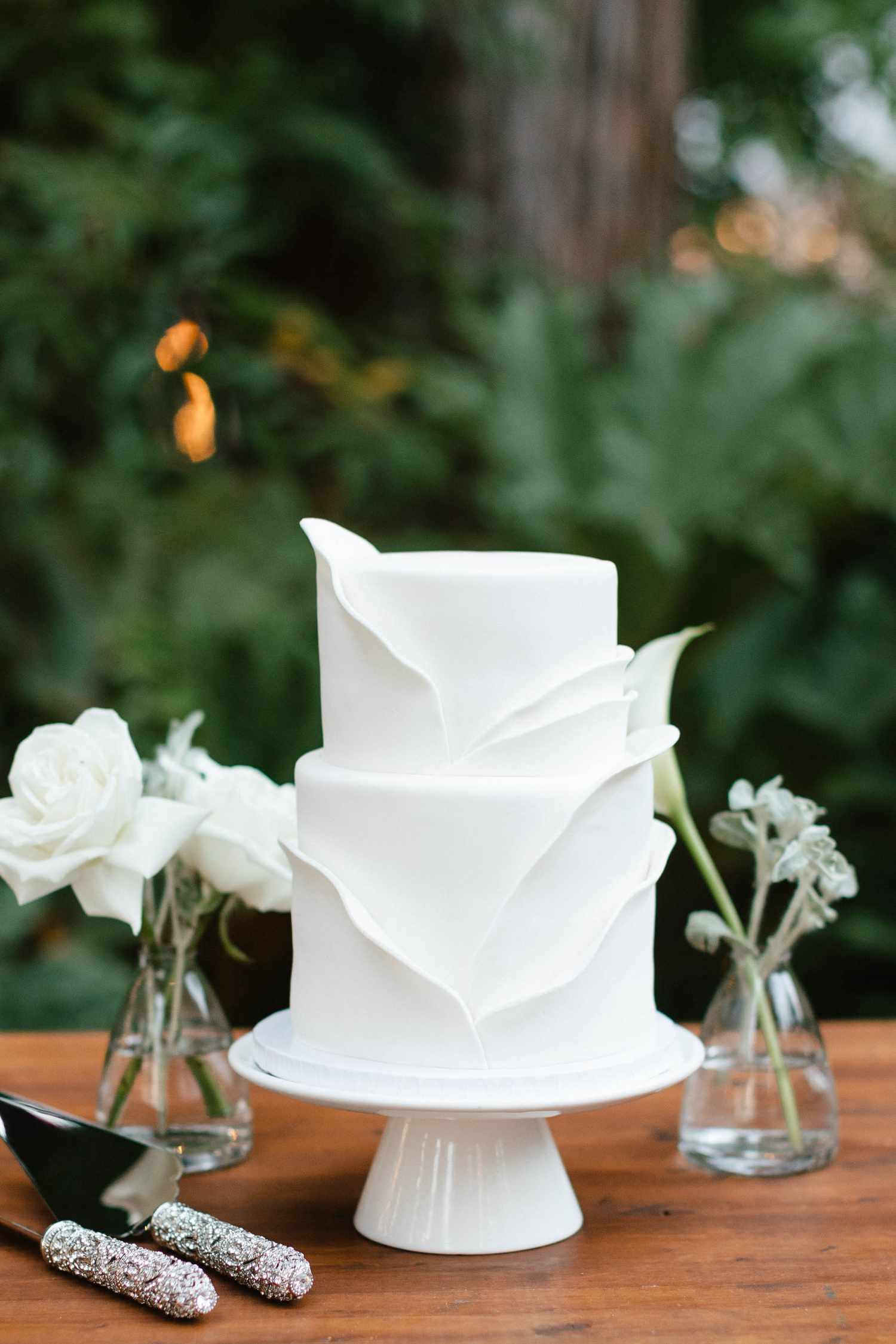 White Two-Tier Wedding Cake With Folded Fondant Design