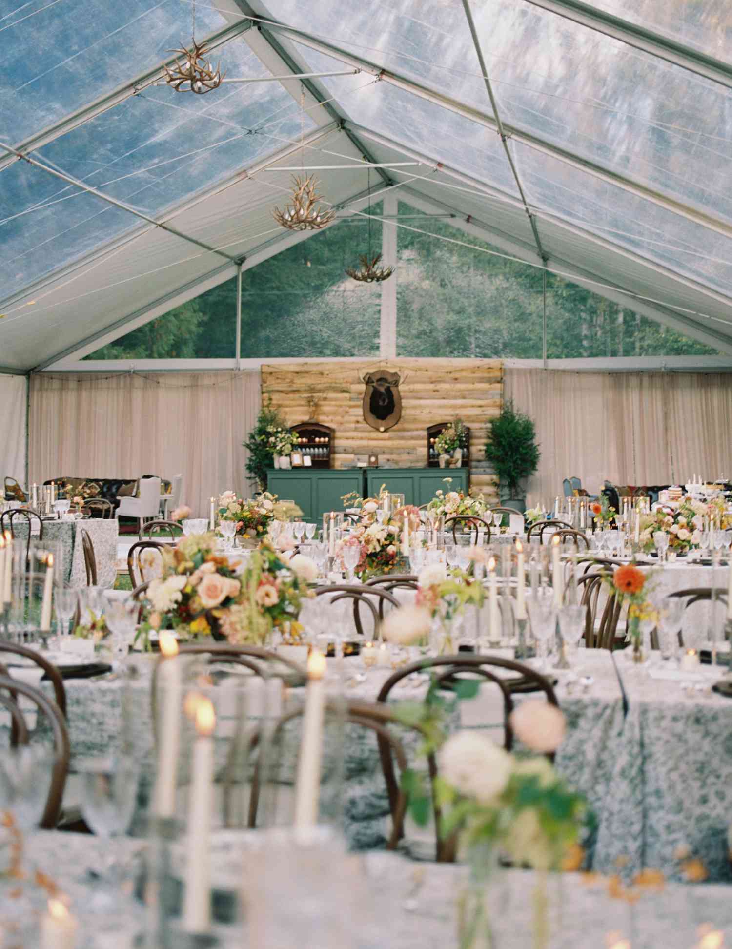 Floral Table Cloths on Reception Tables With White and Pink Flower Decor in Glass Tent