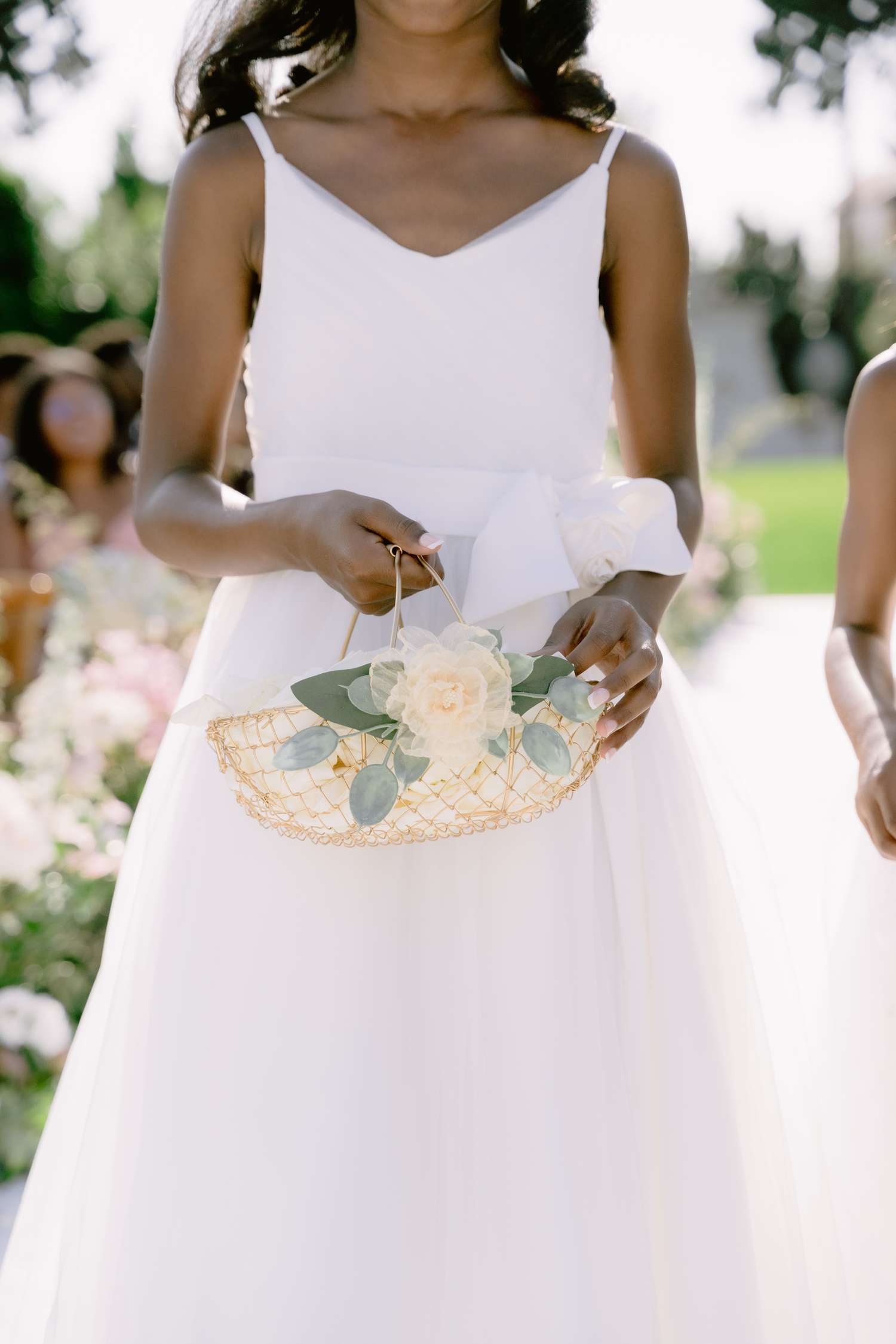 Close Up of Flower Girl in White Dress Holding White Flower Basket