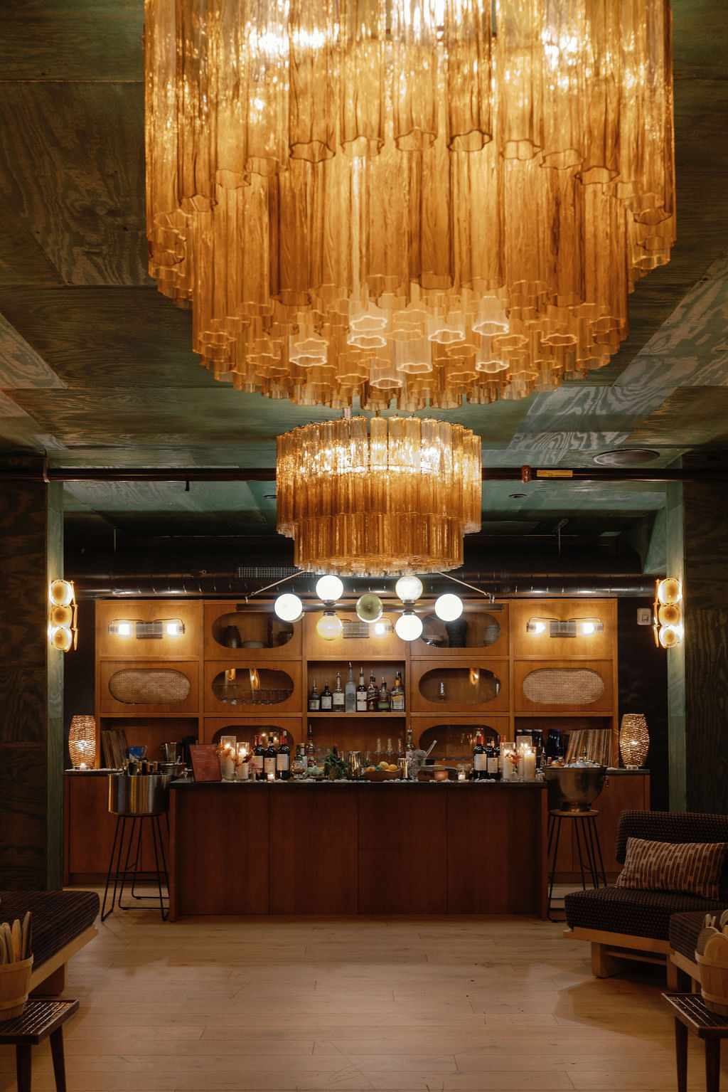 Wooden Green Reception Bar With Large Ornate Chandeliers