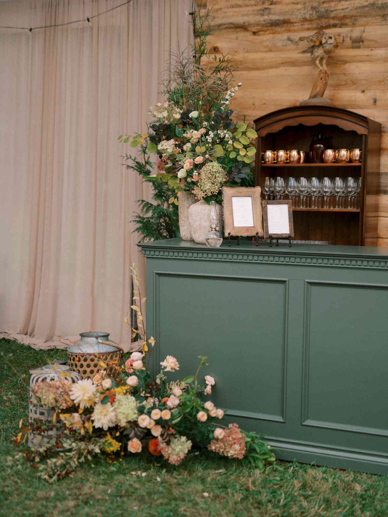 Plant and Flower Decor Next to Green Cocktail Bar At Wedding Reception