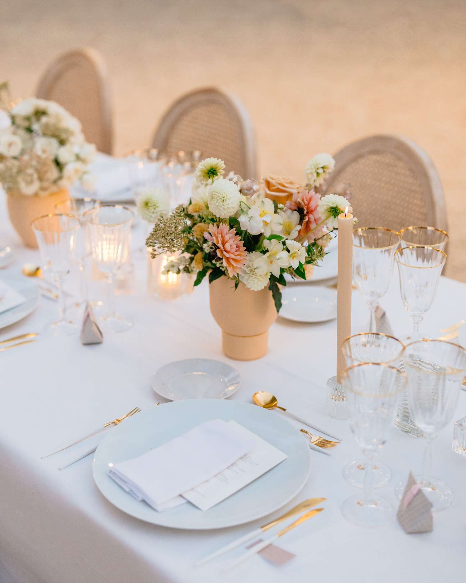 flower bouquet on the table with plates and glassware