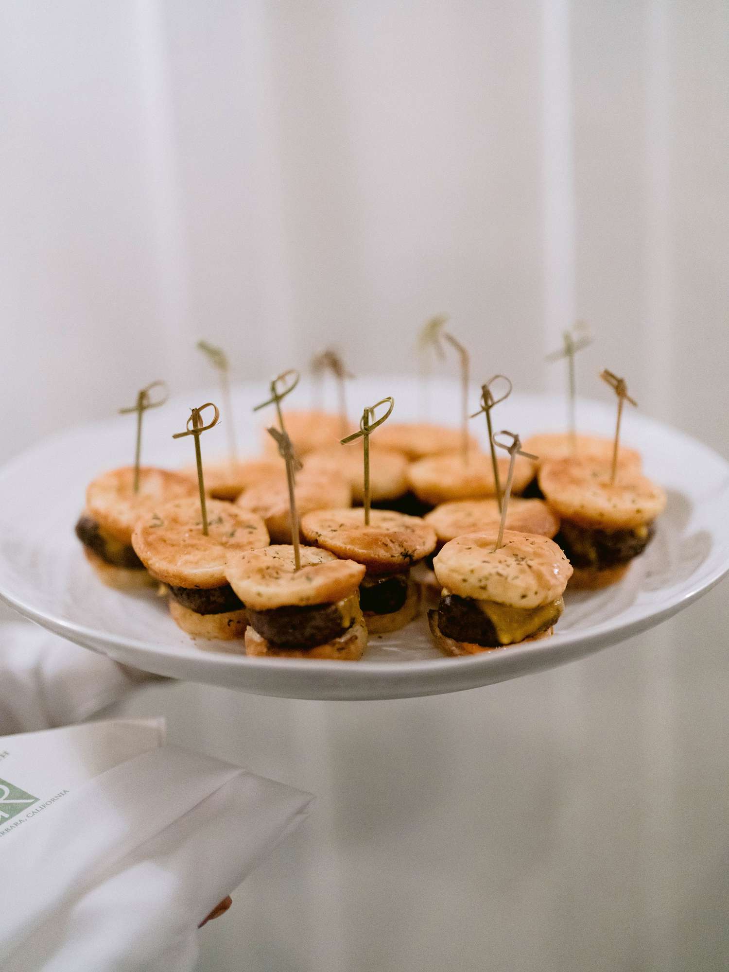 mini cheeseburgers on a white plate