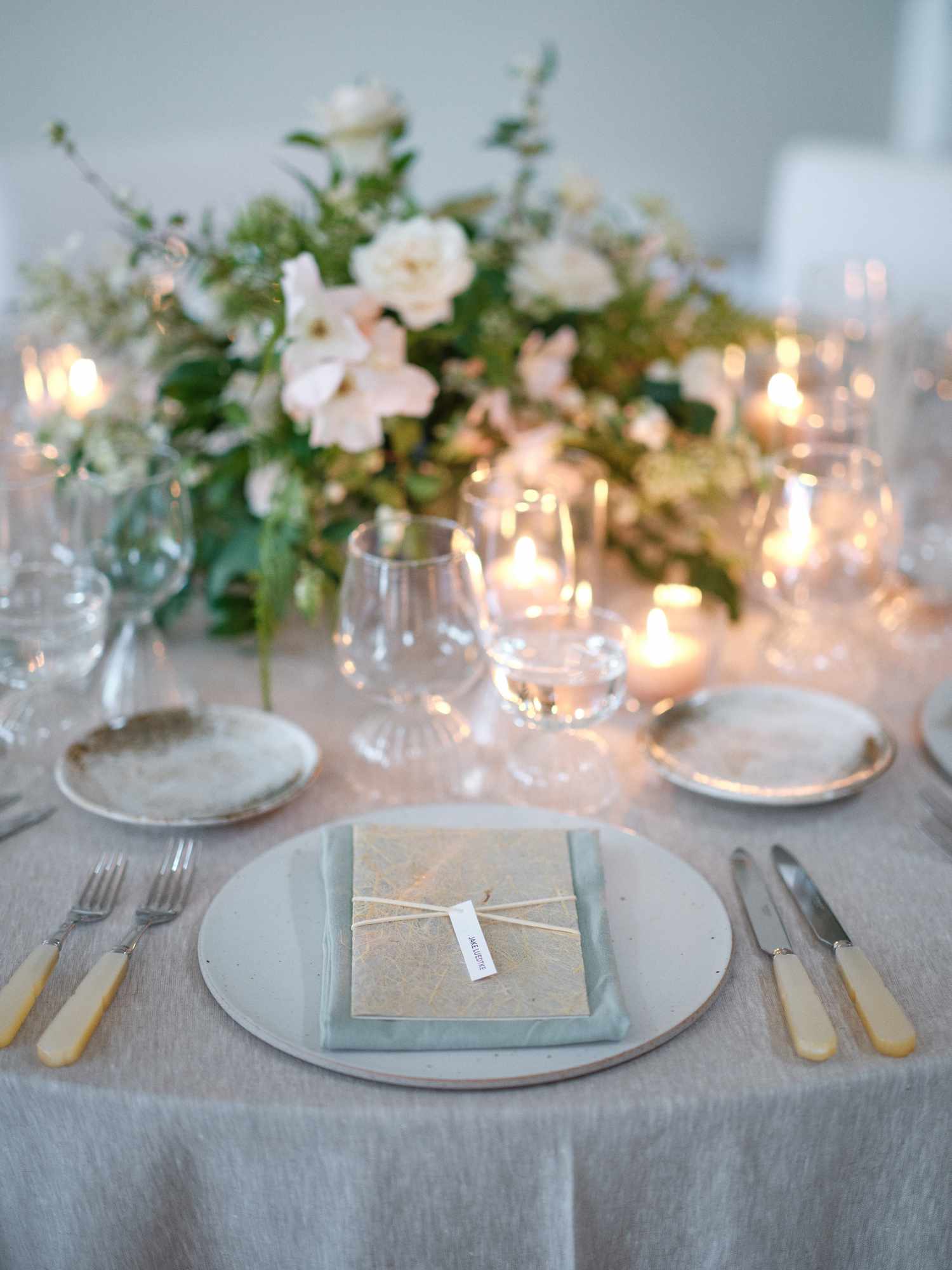 Simple Wedding Reception Table Setting By Candles and White Flower Decor