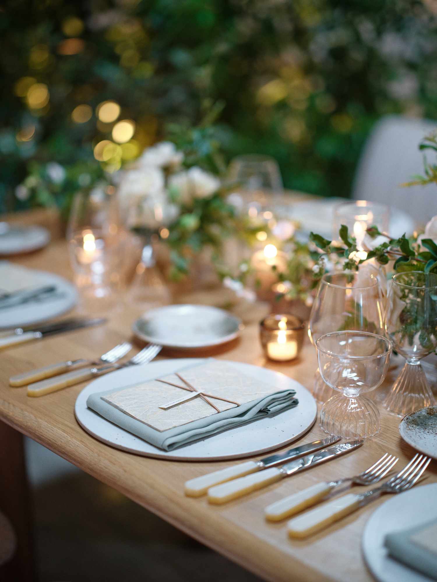 Simple Wedding Reception Table Setting By Candles and White Flower Decor
