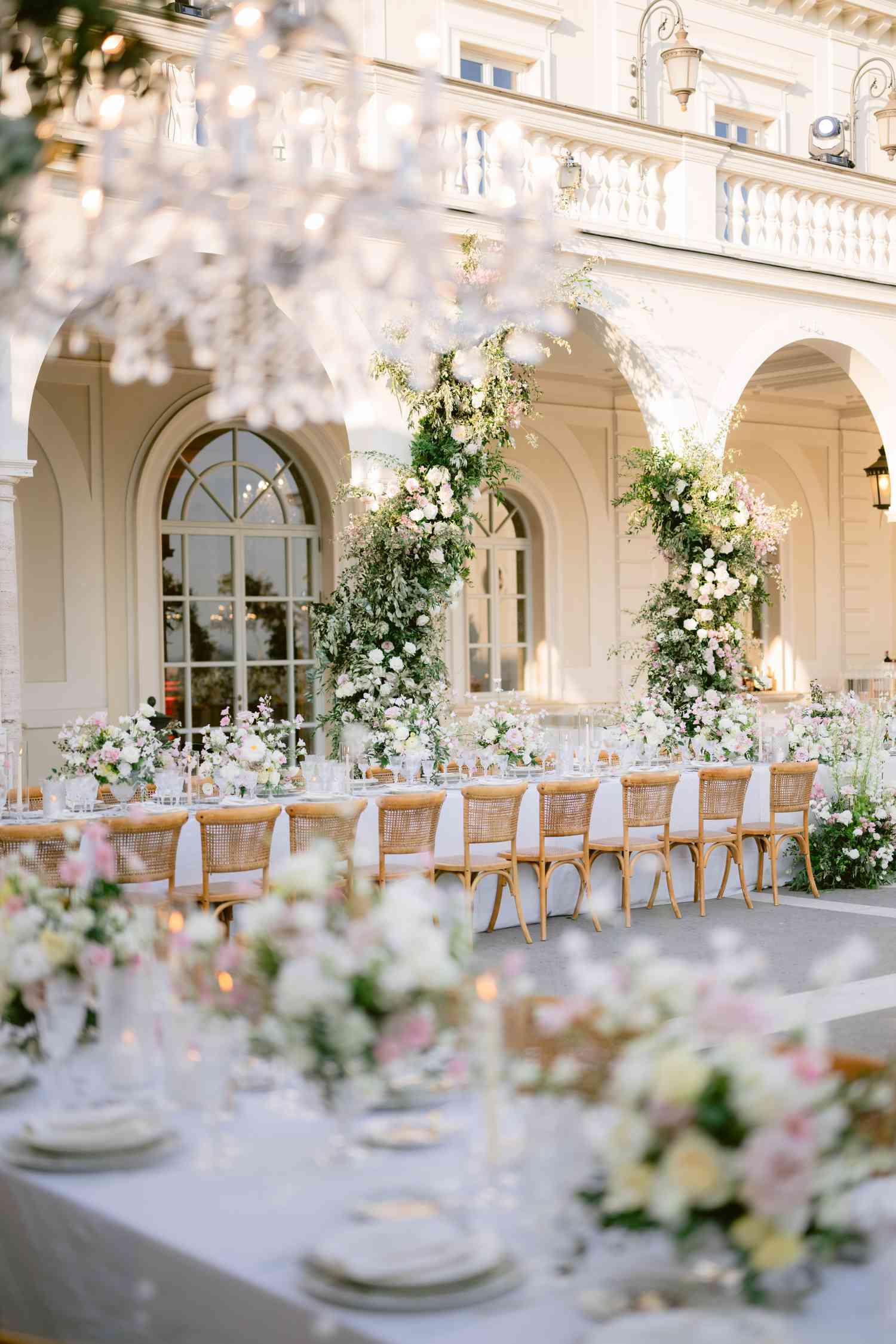 White Flower Decor and Reception Tables in Courtyard of White Villa