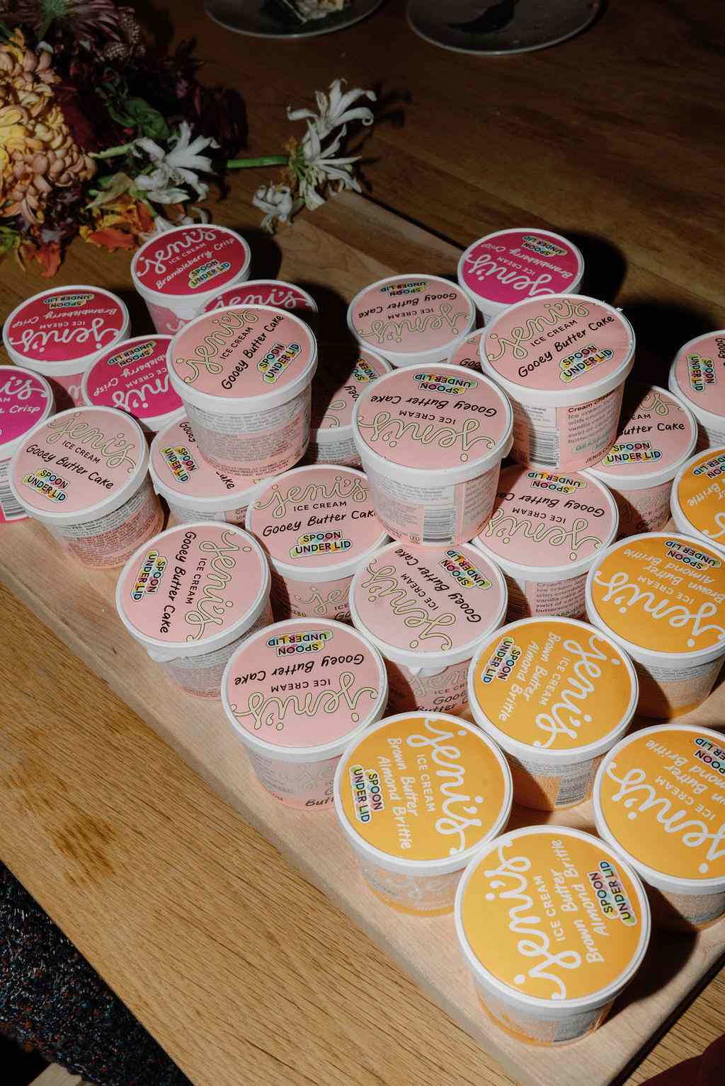 Three Flavors of Ice Cream Tubs on Wooden Tray at Wedding Reception
