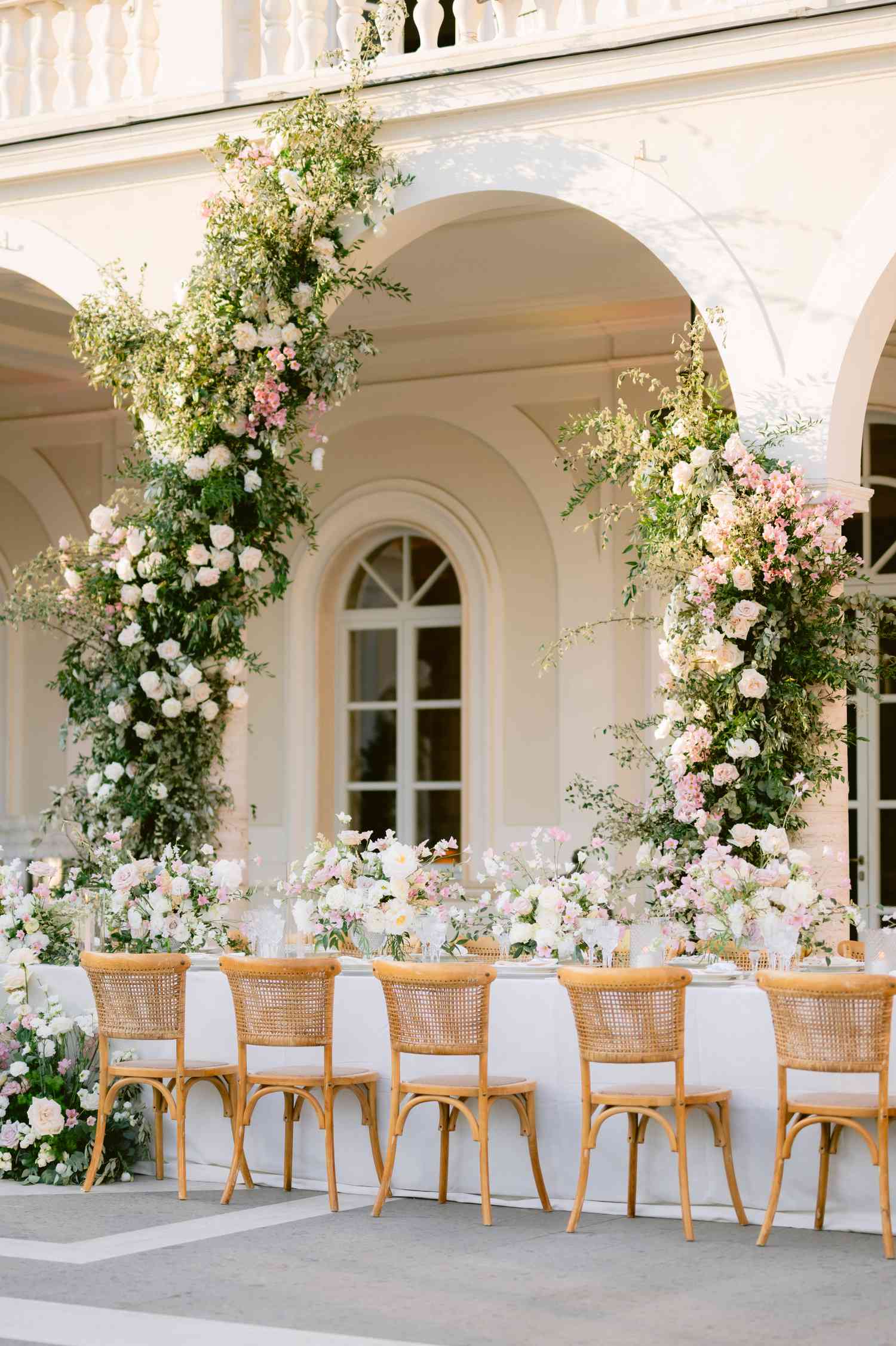 White and Pastel Flower Decor on Reception Tables and on Pillars of White Villa