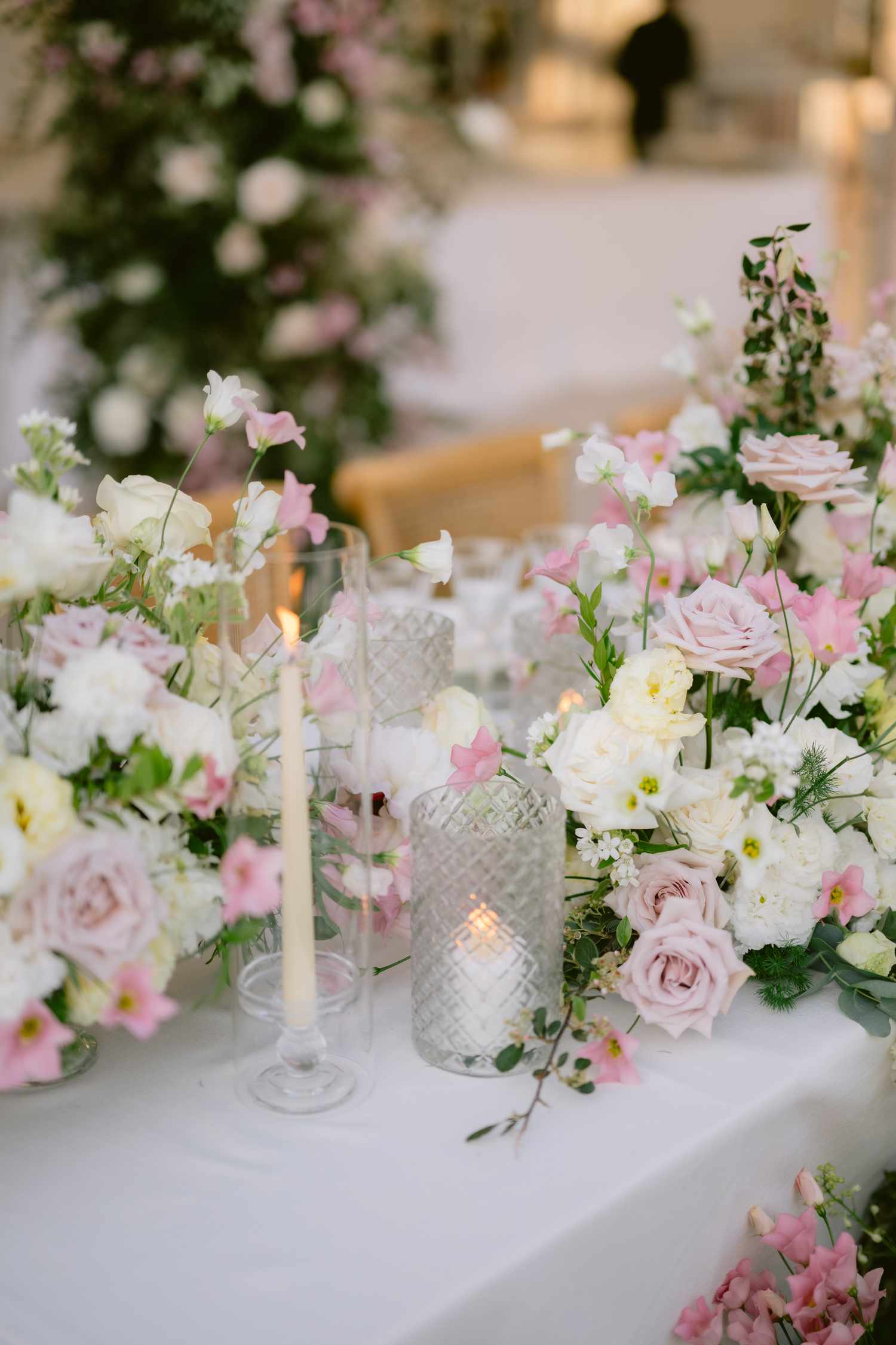 Pink and White Flower Decor Next to Candles on Reception Table