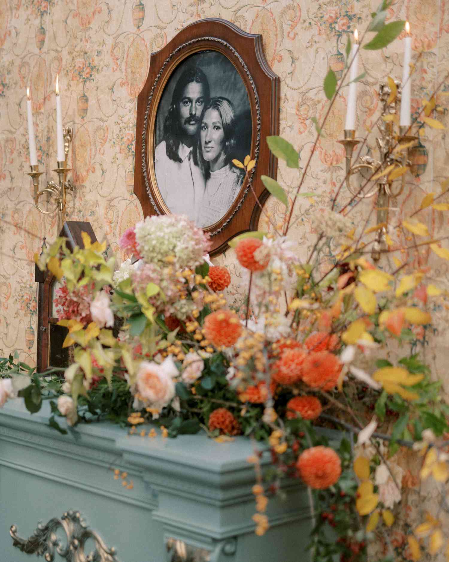Colorful Flower Decor Next to Black and White Portrait of Couple on Wall