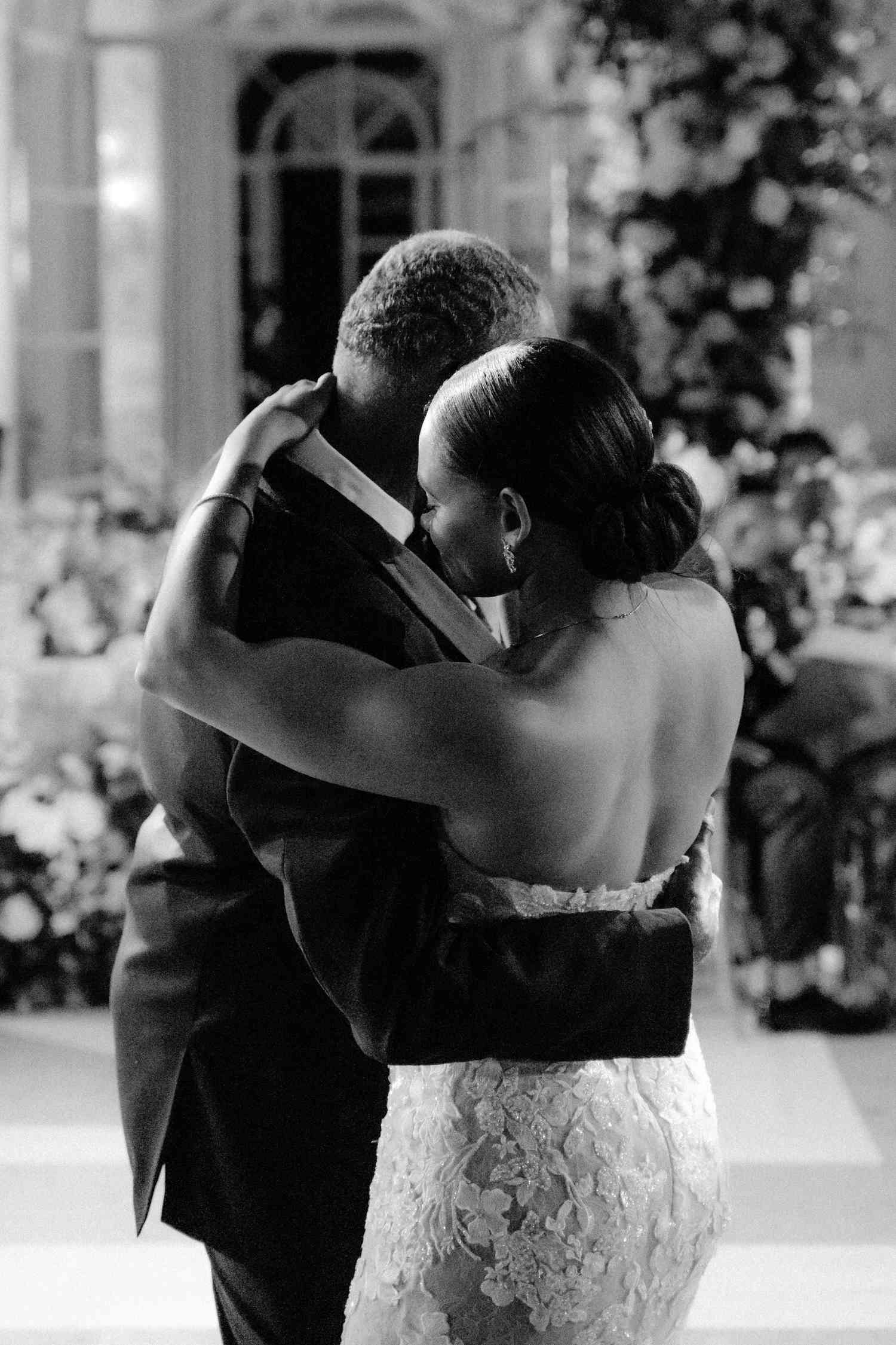 Black and White Portrait of Bride in Lace Wedding Dress Dancing With Father in Tuxedo