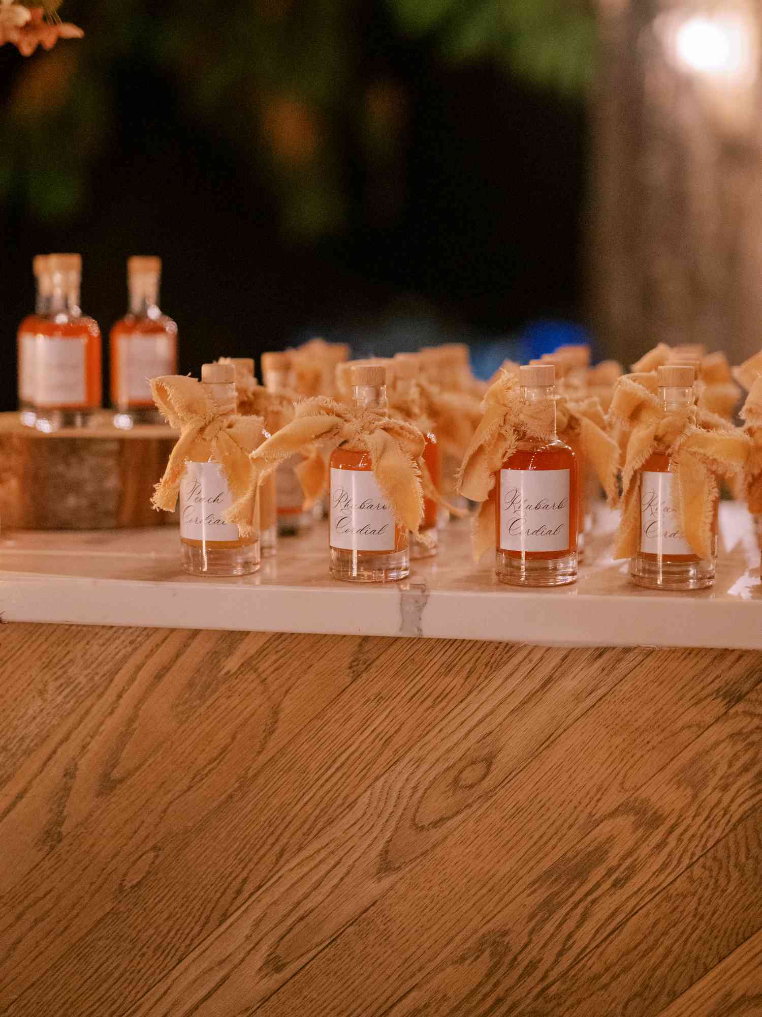 Rhubarb Cordial Bottles on Wooden Bar at Wedding Reception