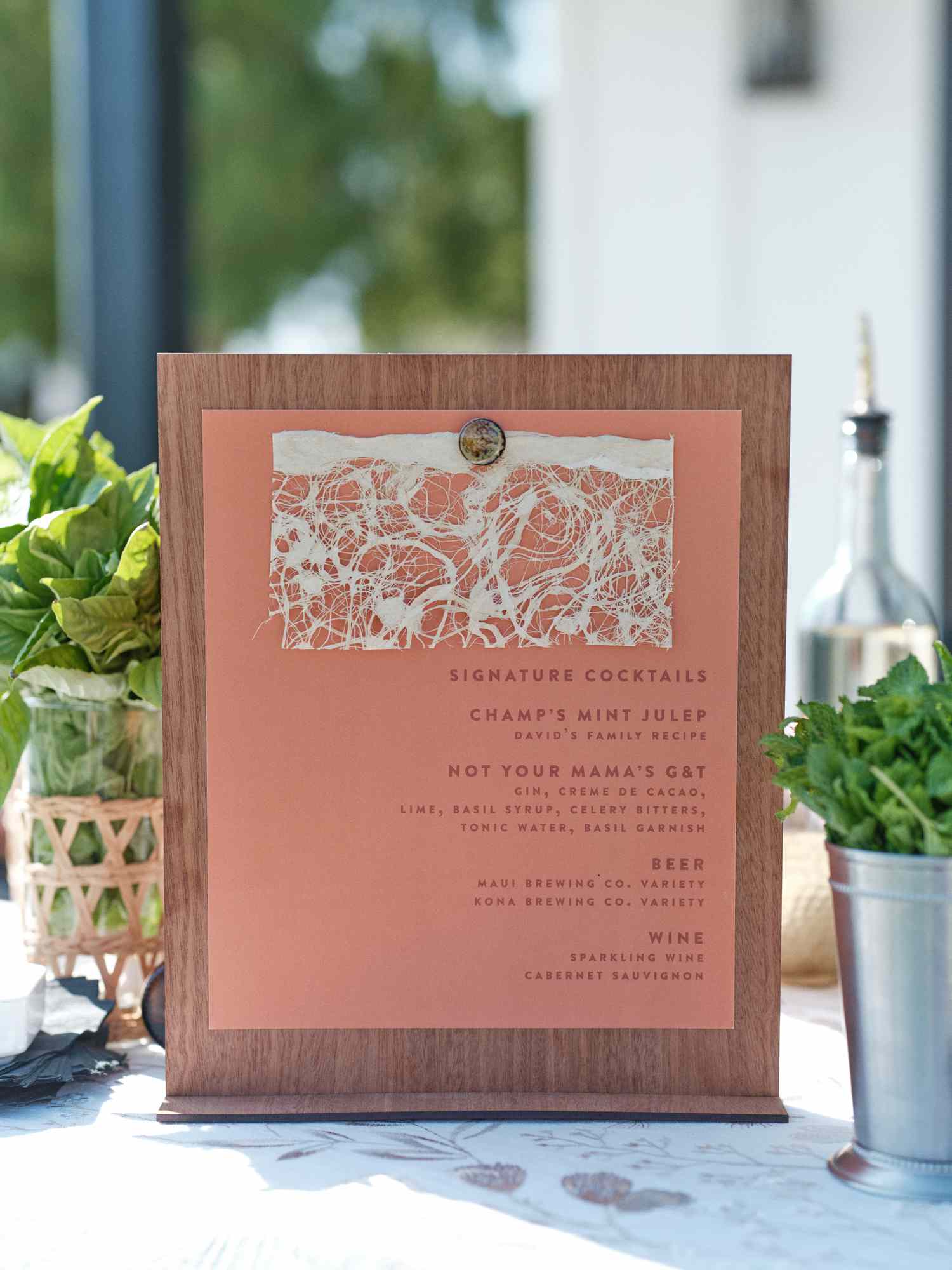 Close Up of Pink Cocktail Menu on Wood Board at Wedding Party