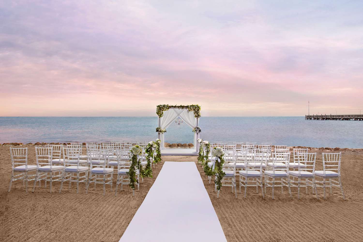 An beach wedding ceremony by the ocean at Casa Marina Key West in Florida