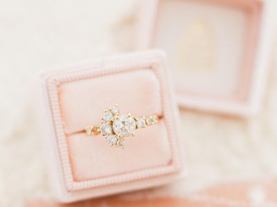 Rose gold engagement ring placed in a velvet blush pink ring box