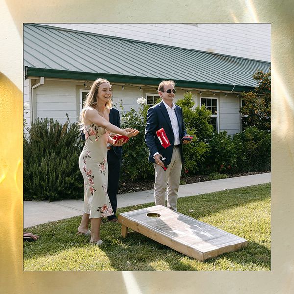 guests playing cornhole at engagement party