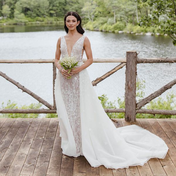 bride posing in front of a lake