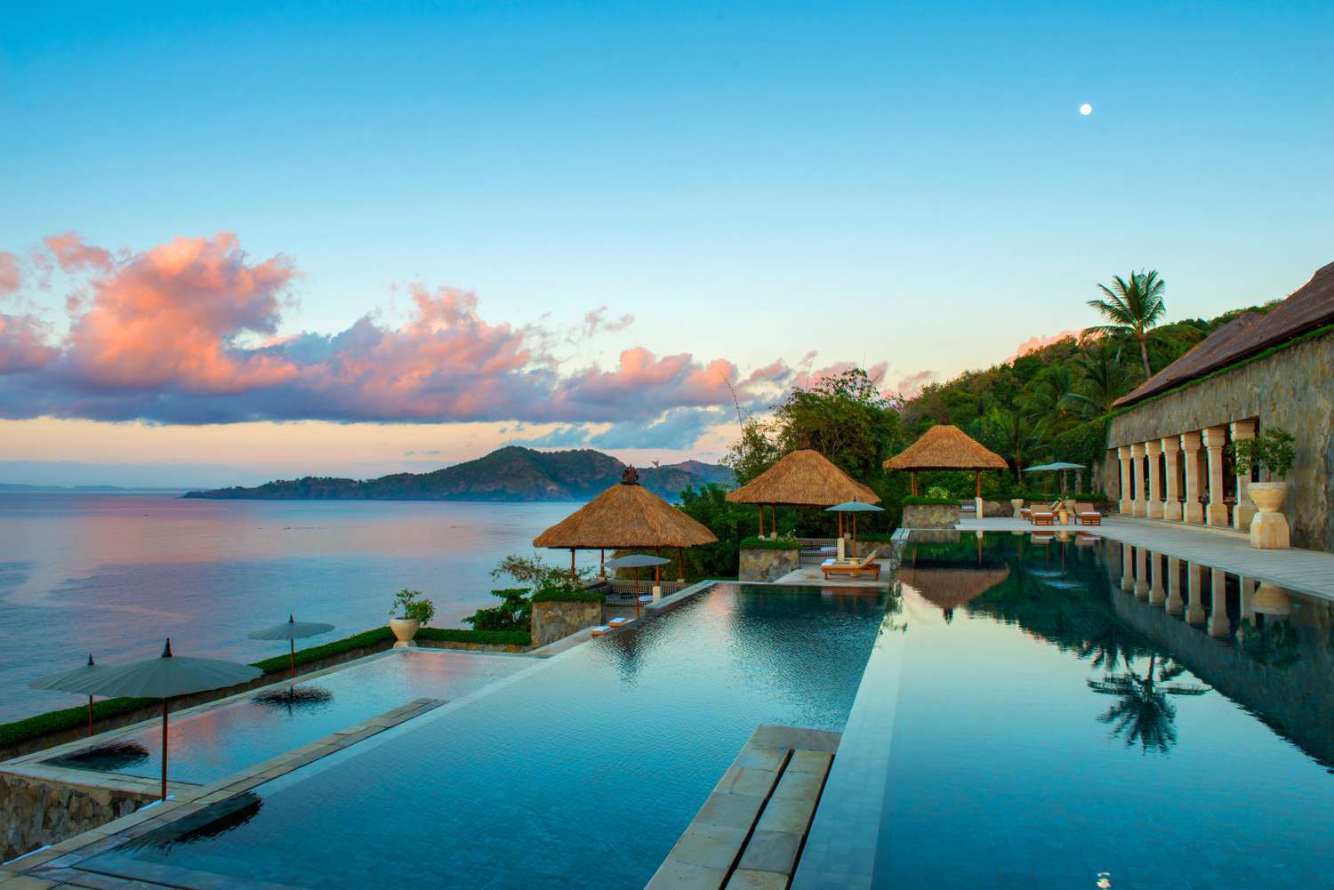 Sunset over Amankila's three-tiered infinity pool in Bali