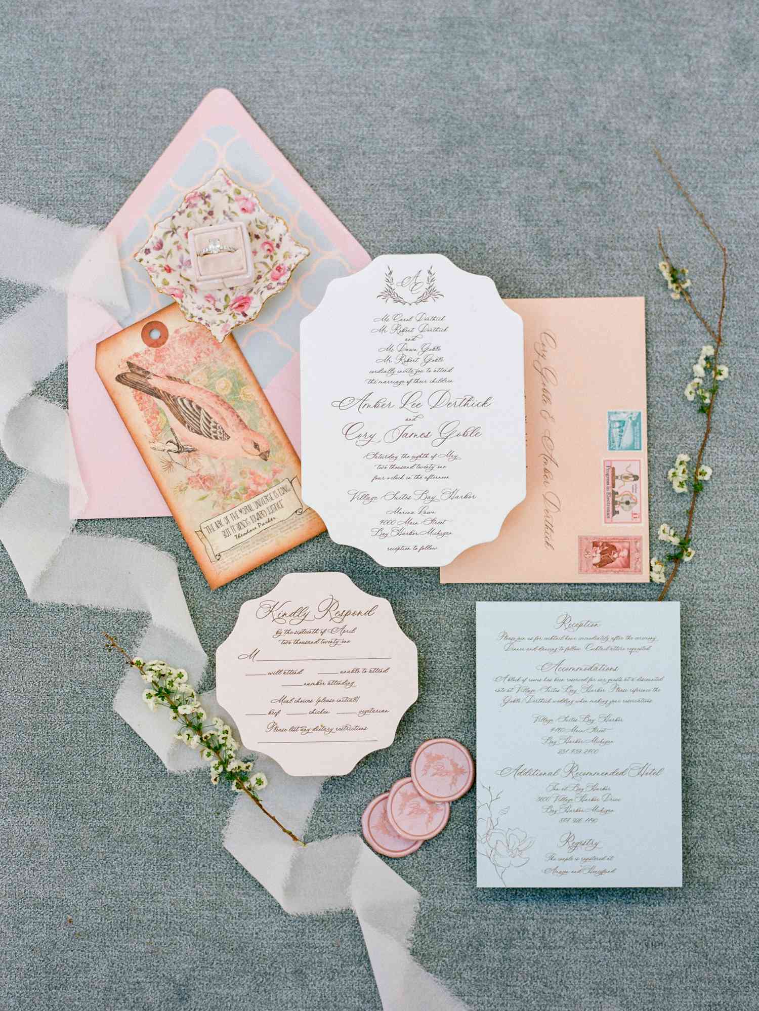 Spring wedding invitation with a pink and blue color palette, illustrated pink bird cards, and a printed envelope liner