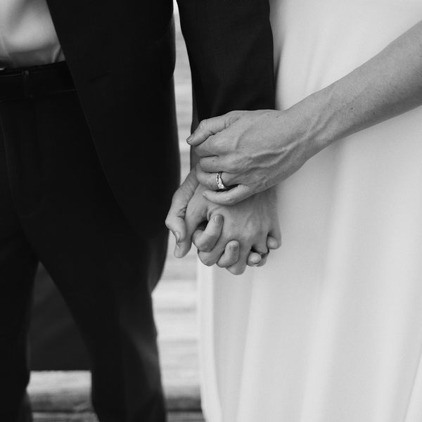 bride and groom holding hands