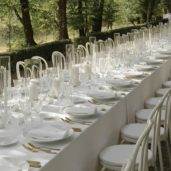 minimalist all-white tablescape with simple plates and candles