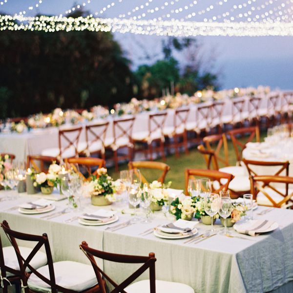 Wedding reception dinner setup with teak chairs in Bali
