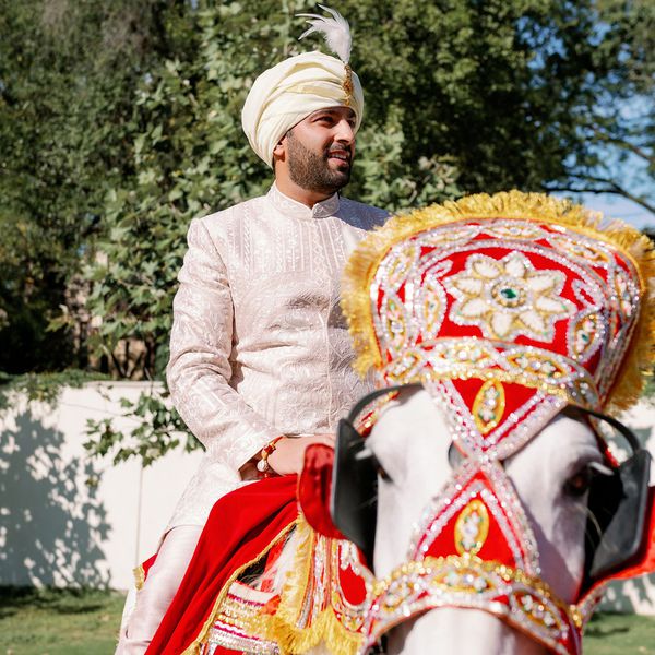 Indian groom sitting on a horse