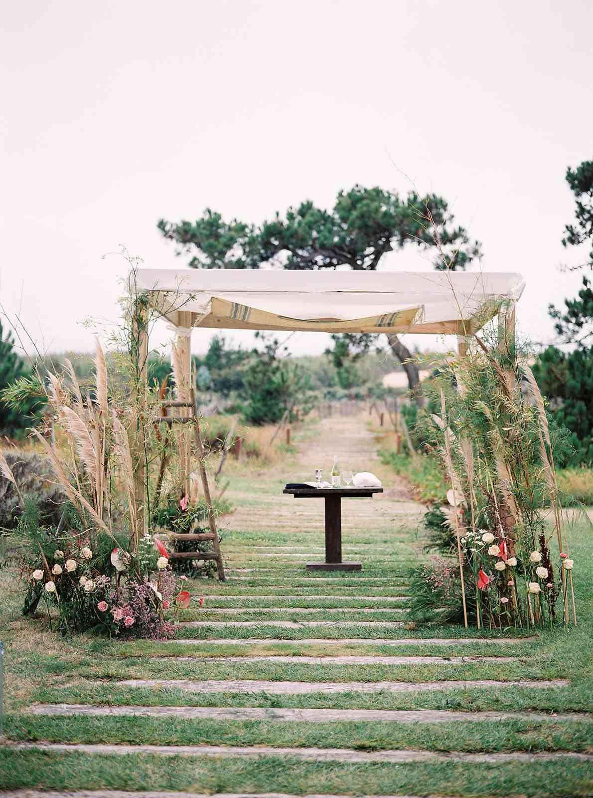 chuppah with pampas grass and bold florals