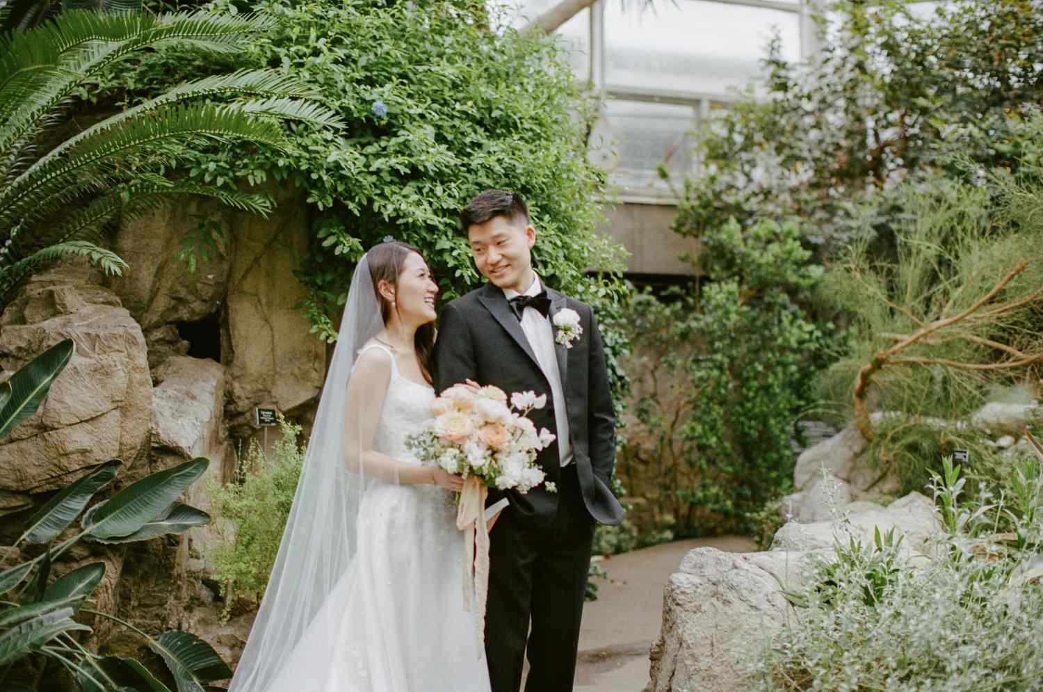 bride and groom posing for a wedding photo in the Brooklyn Botanical Garden
