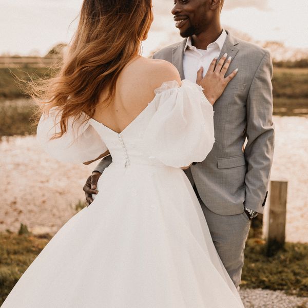 tight shot of a young couple posing for their wedding photo