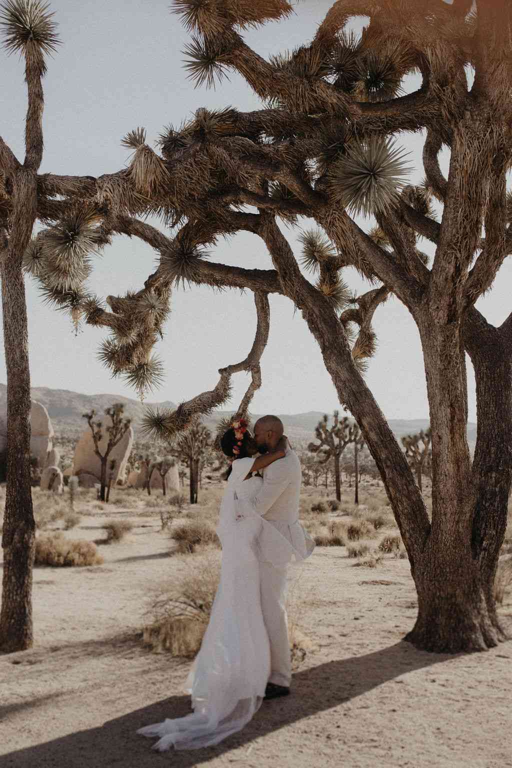Couple Shares a Kiss in the Desert During Their Joshua Tree, California Destination Elopement