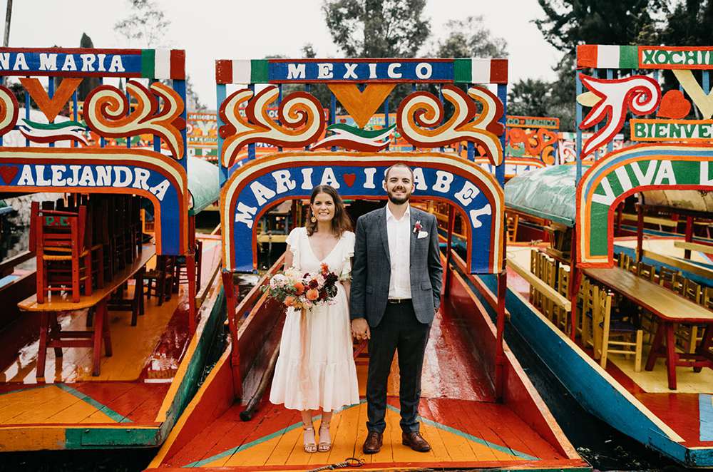 Couple Poses on a Xochimilco Canal Boat During Their Mexico City Destination Elopement