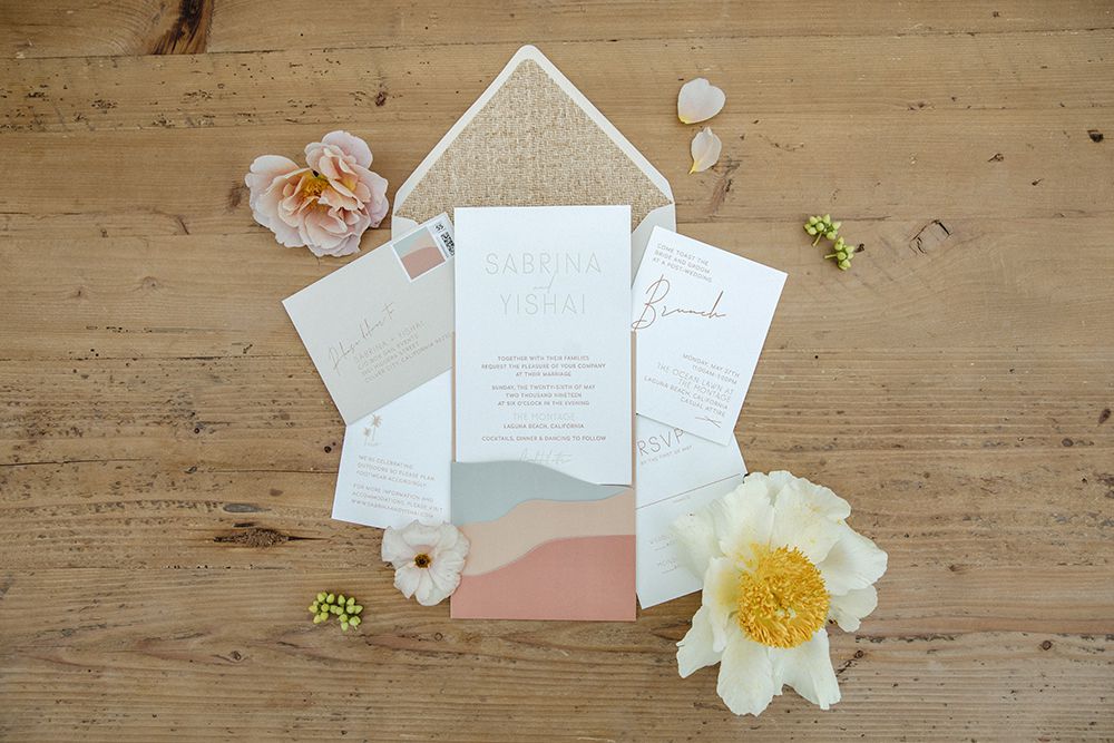Boho wedding invitation with rust, tan, light blue, and white shades and a woven-inspired envelope liner