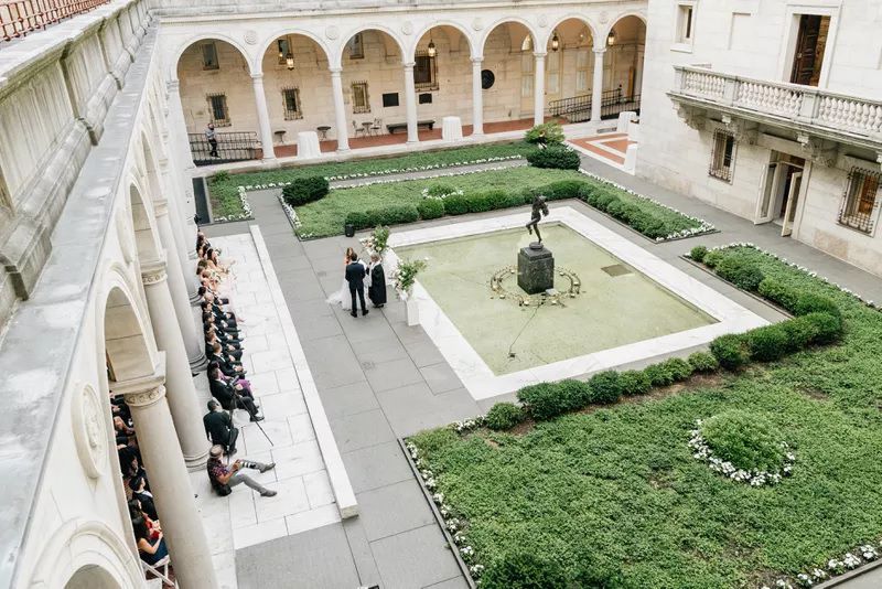 Daytime wedding in the lush courtyard at Boston Public Library in Boston.