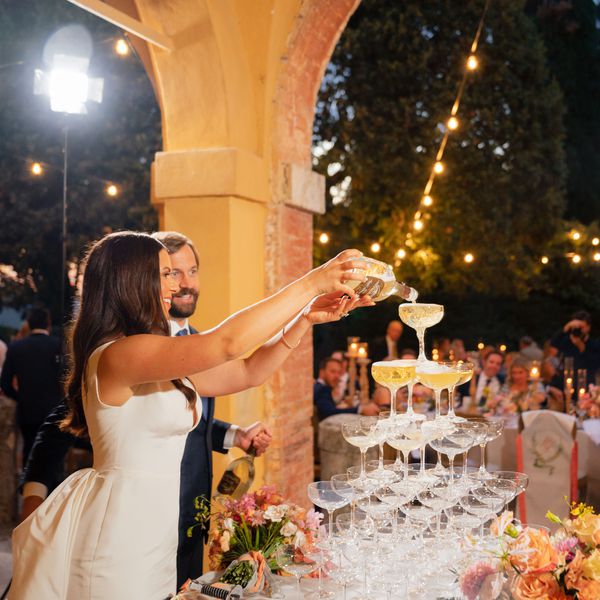 couple pouring champagne tower