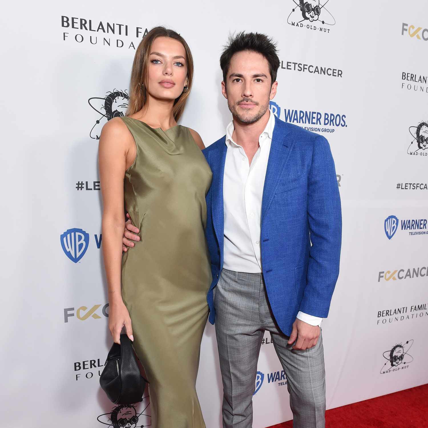 Bregje Heinen and Michael Trevino with their arms around one another on the red carpet