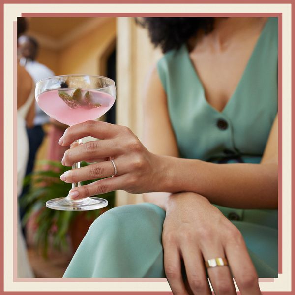 Woman in Green Dress Holding Cocktail