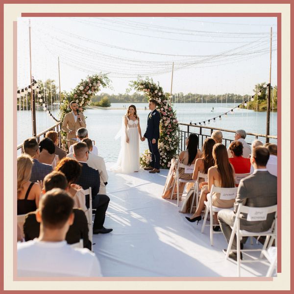 Bride in Wedding Dress and Groom in Tuxedo at Altar in Front of Ocean