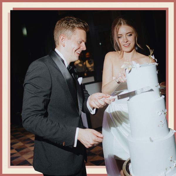 Bride in Wedding Dress Cutting Cake With Groom in Tuxedo