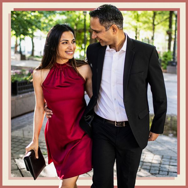 Woman in Red Mini Dress Walking with Man in Black Suit