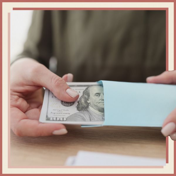Woman Pulling Cash Wedding Tip Out of Blue Envelope