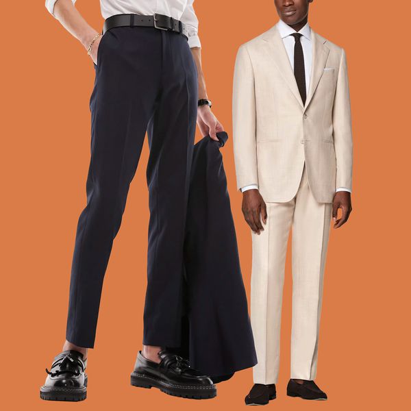 Two people wearing suits bought online in front of an orange background