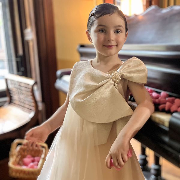 Flower girl posing by piano
