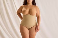 The front profile of a woman wearing the Skims Core Control High Waisted Brief