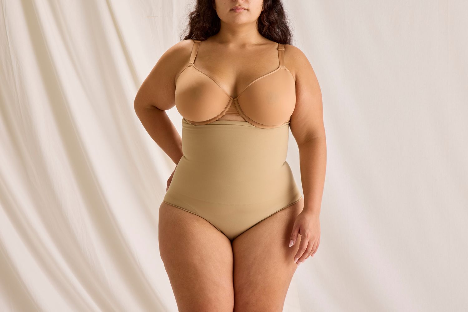 The front profile of a woman wearing the Skims Core Control High Waisted Brief